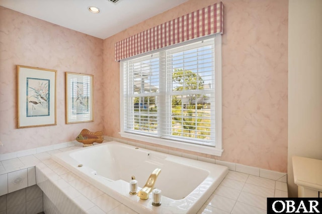bathroom with recessed lighting, a tub with jets, tile patterned flooring, and plenty of natural light