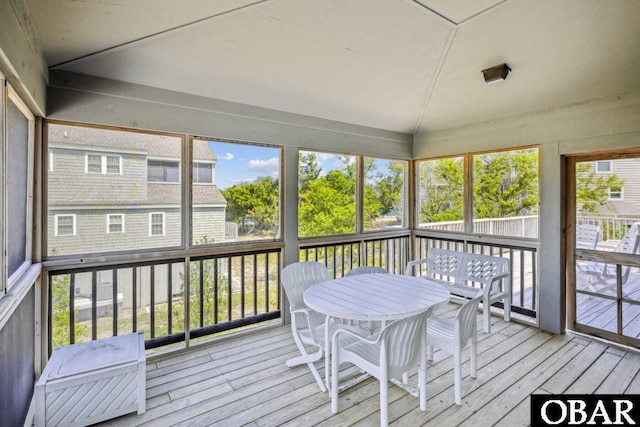 sunroom featuring outdoor dining area