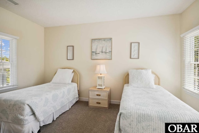 carpeted bedroom featuring baseboards and visible vents