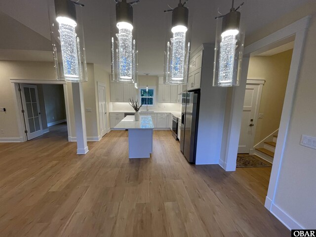 3009 Martins Point Rd Lot 3, Kitty Hawk, NC 27949 - kitchen featuring stainless steel refrigerator with ice dispenser, light countertops, a center island, a sink, and light wood-style floors