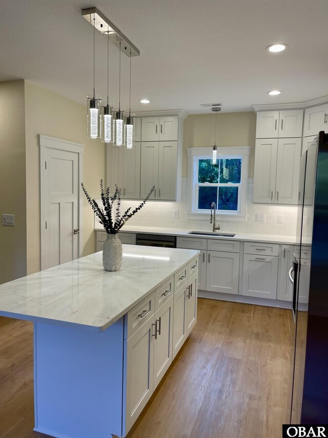 3009 Martins Point Rd Lot 3, Kitty Hawk, NC 27949 - kitchen featuring a sink, light wood-style floors, tasteful backsplash, white cabinetry, and recessed lighting