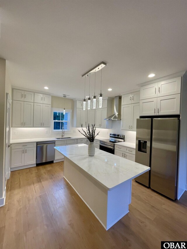 3009 Martins Point Rd Lot 3, Kitty Hawk, NC 27949 - kitchen with stainless steel appliances, wall chimney exhaust hood, a sink, light wood-type flooring, and recessed lighting