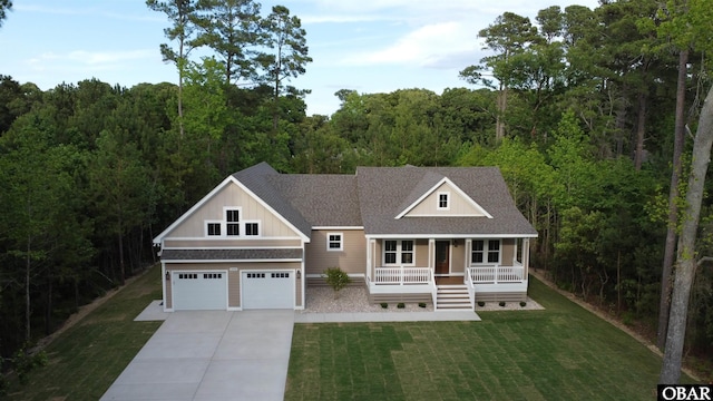 3009 Martins Point Rd Lot 3, Kitty Hawk, NC 27949 - view of front of home featuring a porch, concrete driveway, a shingled roof, and a front yard