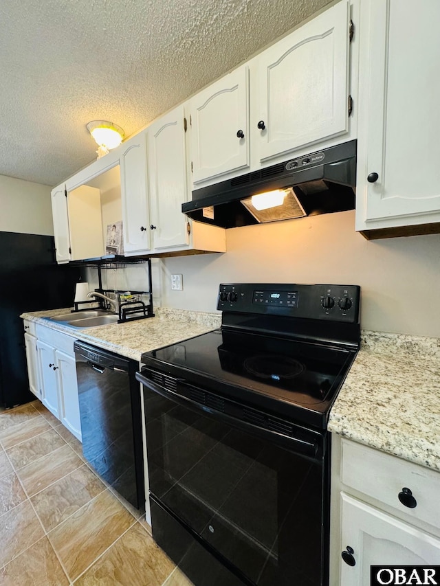 25 Croatan Ct Unit 25, Manteo, NC 27954 - kitchen with black appliances, under cabinet range hood, white cabinets, a sink, and a textured ceiling