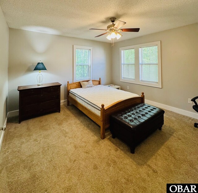 25 Croatan Ct Unit 25, Manteo, NC 27954 - bedroom with a textured ceiling, light colored carpet, baseboards, and a ceiling fan
