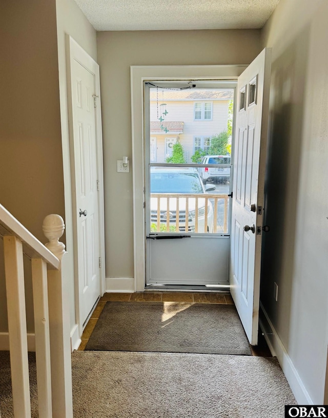 25 Croatan Ct Unit 25, Manteo, NC 27954 - carpeted entrance foyer featuring baseboards and a textured ceiling