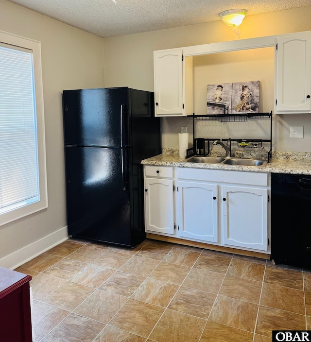 25 Croatan Ct Unit 25, Manteo, NC 27954 - kitchen with black appliances, a sink, white cabinets, baseboards, and a textured ceiling