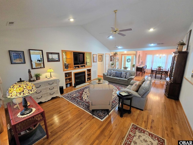 living room with wood finished floors, lofted ceiling, a ceiling fan, and recessed lighting
