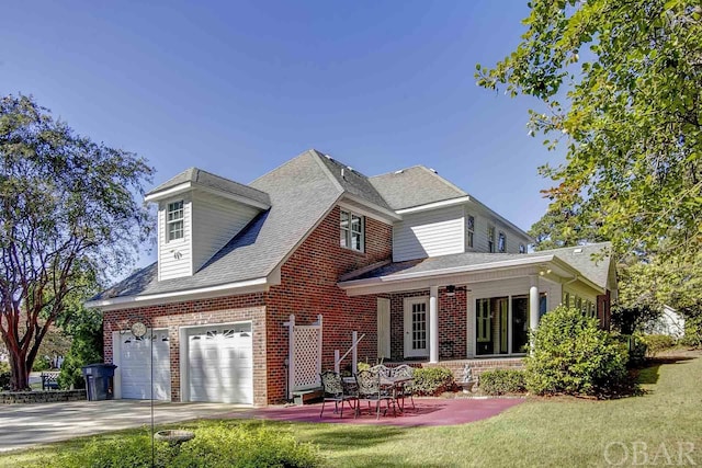 view of front of house with a garage, concrete driveway, brick siding, and a front lawn