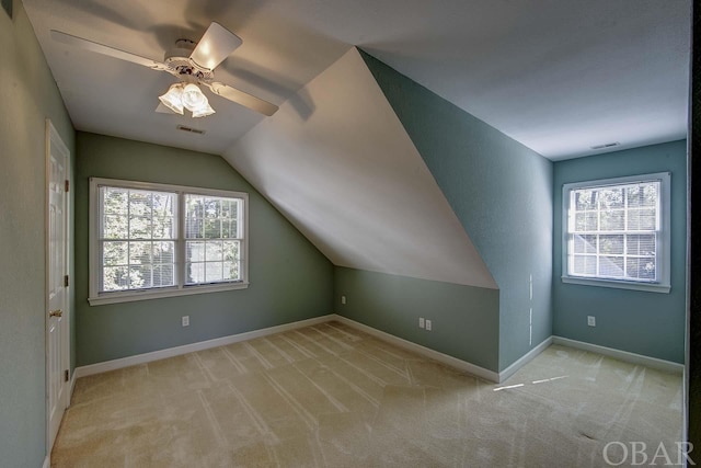 bonus room featuring light colored carpet, plenty of natural light, visible vents, and baseboards