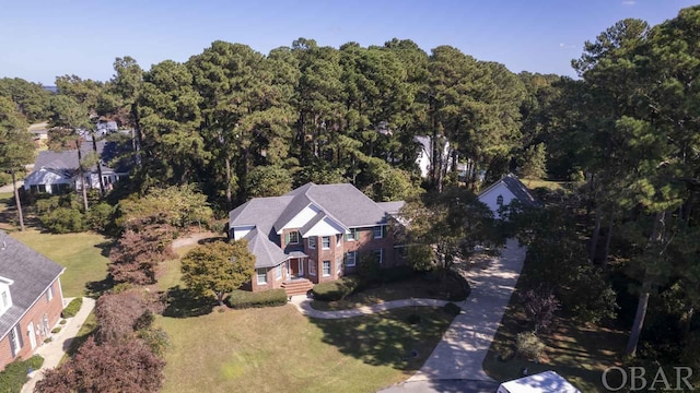 birds eye view of property with a wooded view