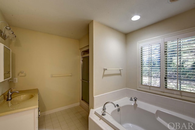 bathroom featuring tile patterned floors, a shower stall, vanity, baseboards, and a bath