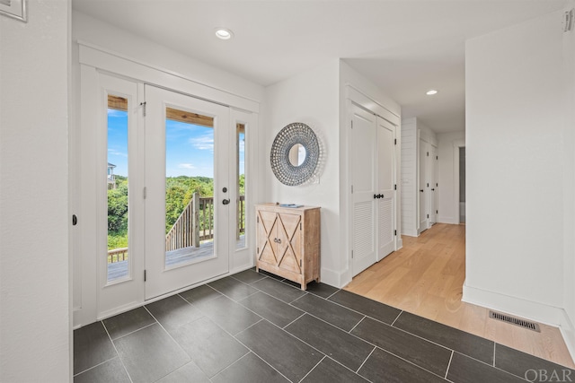 entrance foyer featuring recessed lighting, dark wood-style flooring, visible vents, and baseboards