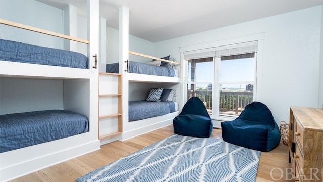 bedroom featuring baseboards and wood finished floors