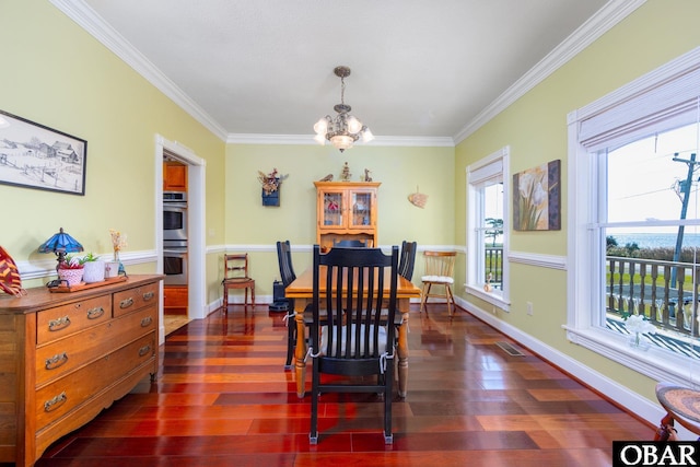 dining space featuring baseboards, visible vents, dark wood-type flooring, and a notable chandelier