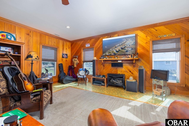 carpeted living room with wooden walls, recessed lighting, visible vents, and crown molding