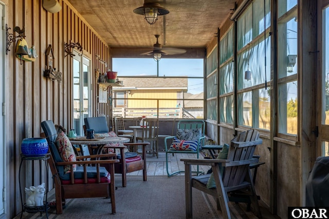 sunroom featuring wooden ceiling, plenty of natural light, and ceiling fan