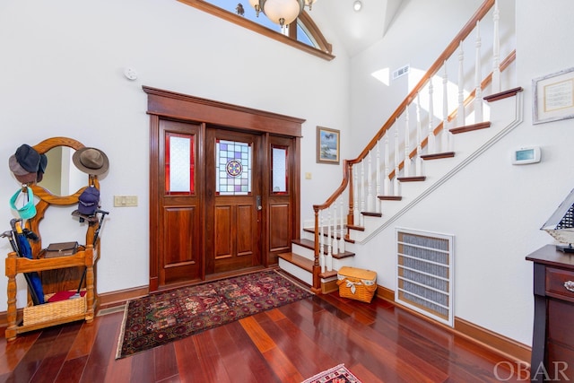 entryway featuring visible vents, stairs, baseboards, and dark wood-style flooring