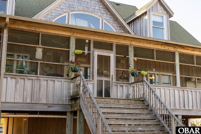 property entrance with a shingled roof