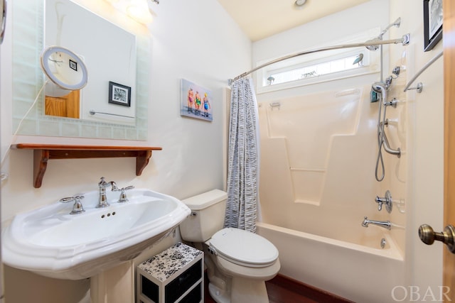 full bathroom featuring shower / bath combo, a sink, and toilet