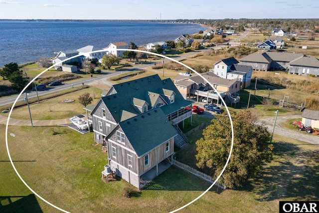 drone / aerial view featuring a water view and a residential view