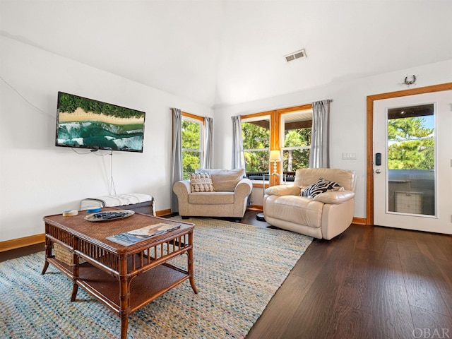 living area featuring dark wood-style flooring, visible vents, baseboards, and french doors