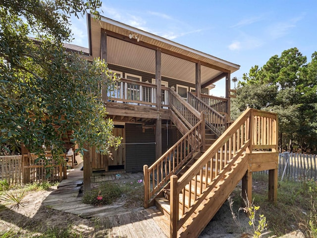 exterior space with fence, stairway, and a wooden deck