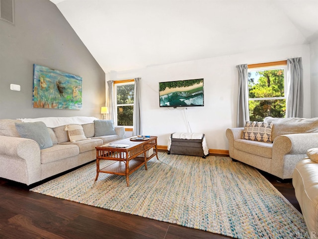 living area featuring vaulted ceiling, visible vents, plenty of natural light, and wood finished floors