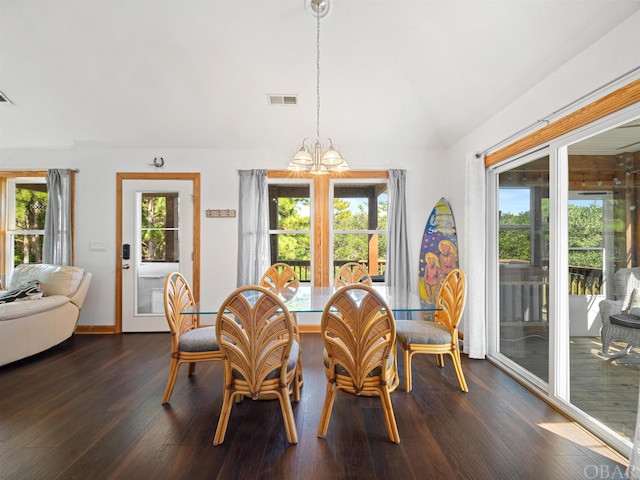 dining room with vaulted ceiling, plenty of natural light, dark wood finished floors, and visible vents