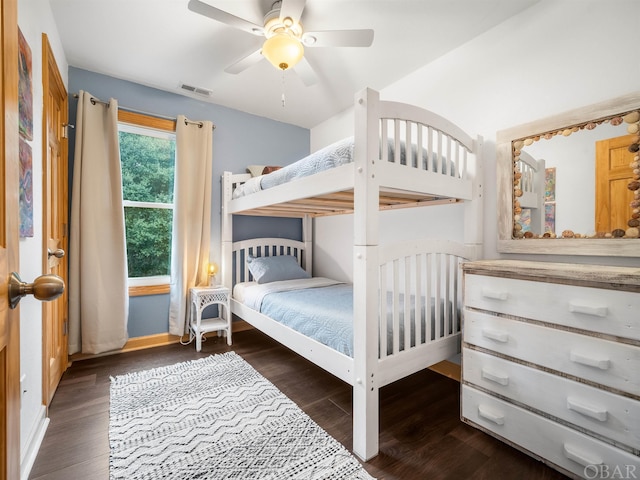 bedroom with dark wood finished floors, visible vents, and a ceiling fan