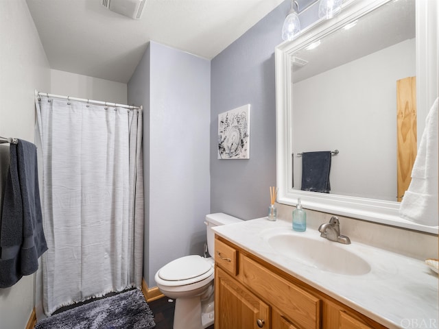 bathroom featuring visible vents, vanity, and toilet