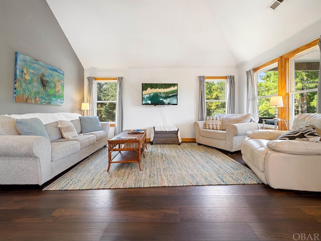 living room featuring dark wood-type flooring, visible vents, and high vaulted ceiling