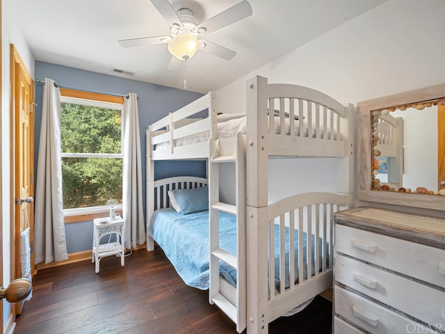 bedroom with visible vents, dark wood finished floors, and a ceiling fan