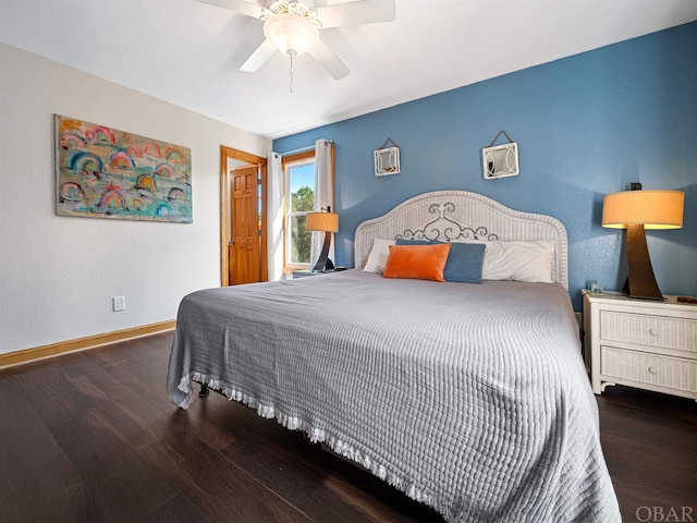 bedroom featuring ceiling fan, dark wood-type flooring, and baseboards