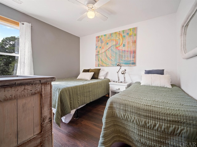 bedroom featuring a ceiling fan and dark wood-type flooring