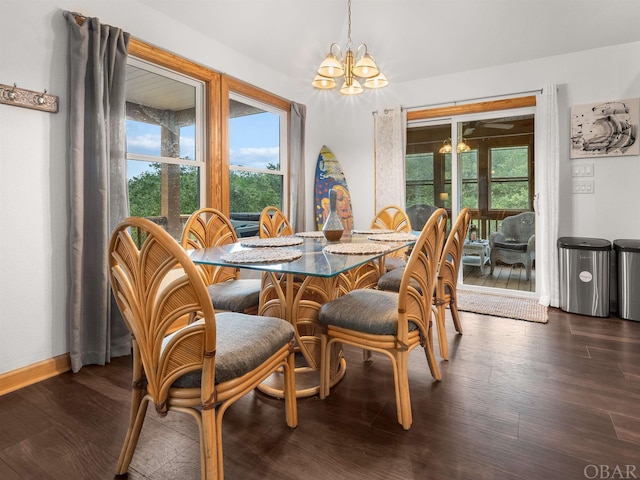 dining space featuring baseboards, dark wood-style flooring, and a notable chandelier