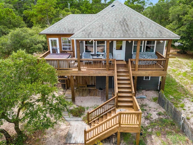 back of property with a shingled roof, fence, a deck, and stairs