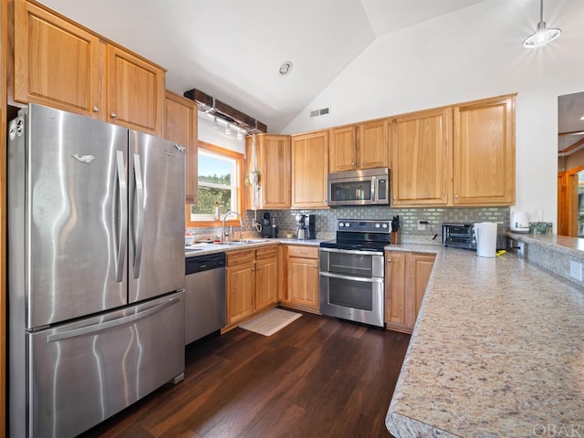 kitchen with stainless steel appliances, tasteful backsplash, light countertops, visible vents, and a sink