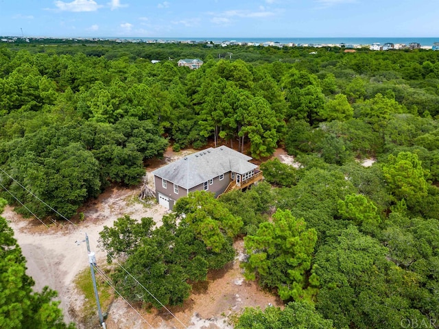 drone / aerial view featuring a wooded view