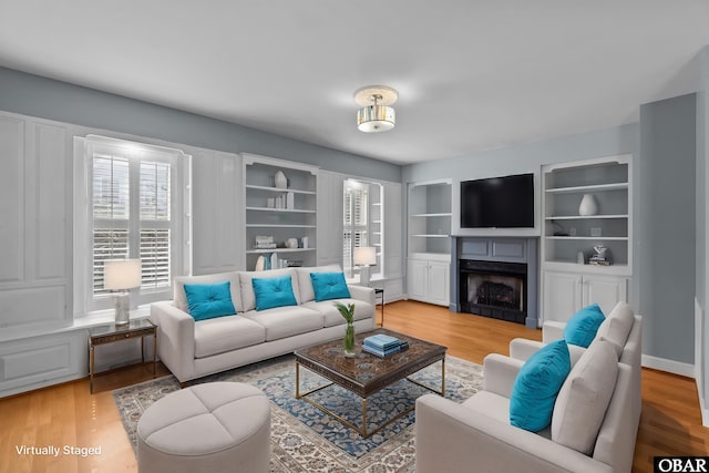 living area with a fireplace and light wood finished floors