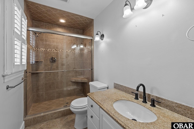 full bath featuring toilet, a shower stall, tile patterned flooring, and vanity