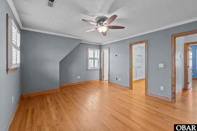 bonus room featuring light wood-style floors, baseboards, visible vents, and ceiling fan