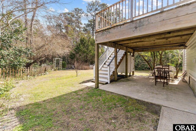 view of yard featuring a patio area, fence, and stairway