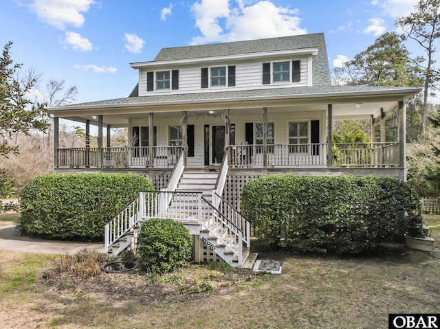 farmhouse inspired home featuring covered porch, a shingled roof, and stairs