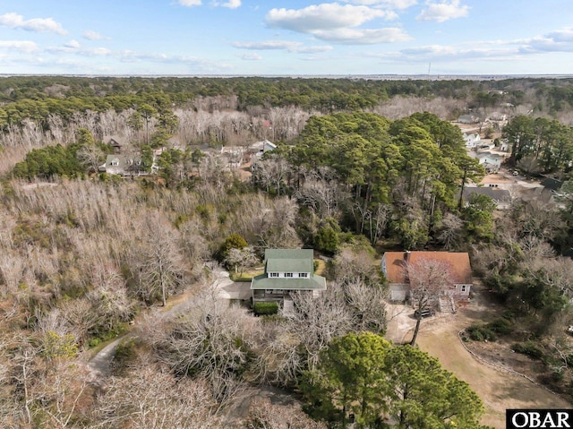 birds eye view of property with a view of trees