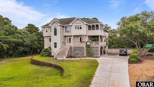 409 W Raceview Ct Lot # 35, Nags Head, NC 27959 - view of front of property featuring stairs, driveway, a front lawn, and a balcony