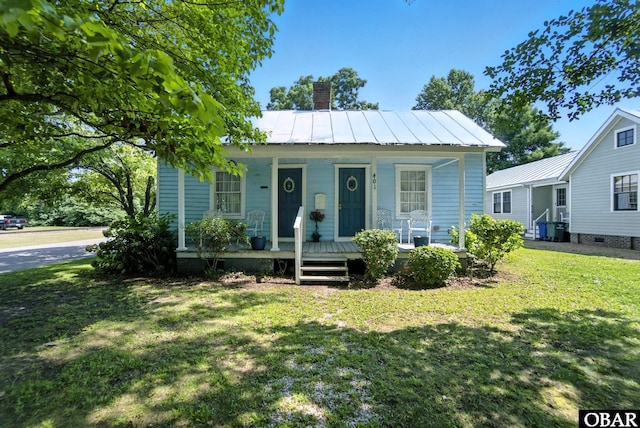 401 E Queen St, Edenton, NC 27932 - view of front of property with a chimney, covered porch, a front yard, a metal roof, and a standing seam roof