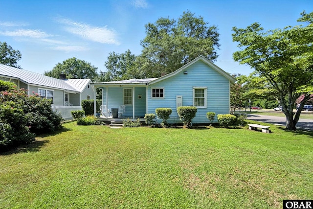 401 E Queen St, Edenton, NC 27932 - view of front of property with a porch, a front lawn, and a metal roof
