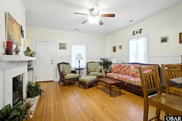 401 E Queen St, Edenton, NC 27932 - living room with ceiling fan, wainscoting, a glass covered fireplace, light wood-style floors, and crown molding