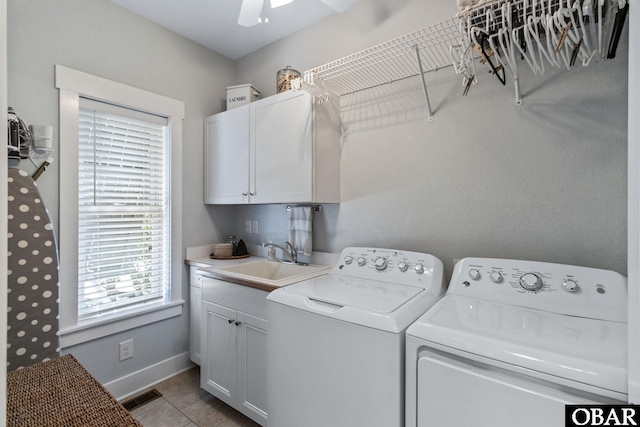 clothes washing area featuring ceiling fan, a sink, visible vents, separate washer and dryer, and cabinet space